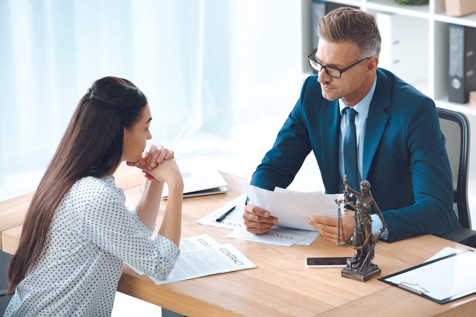 Two professionals discussing legal documents