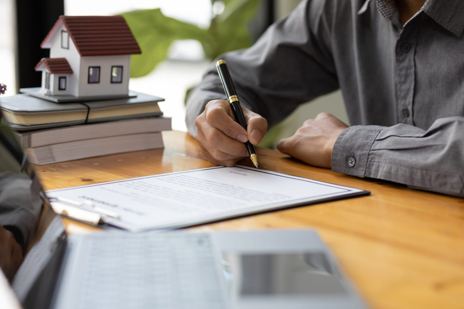 Writing on contract near laptop