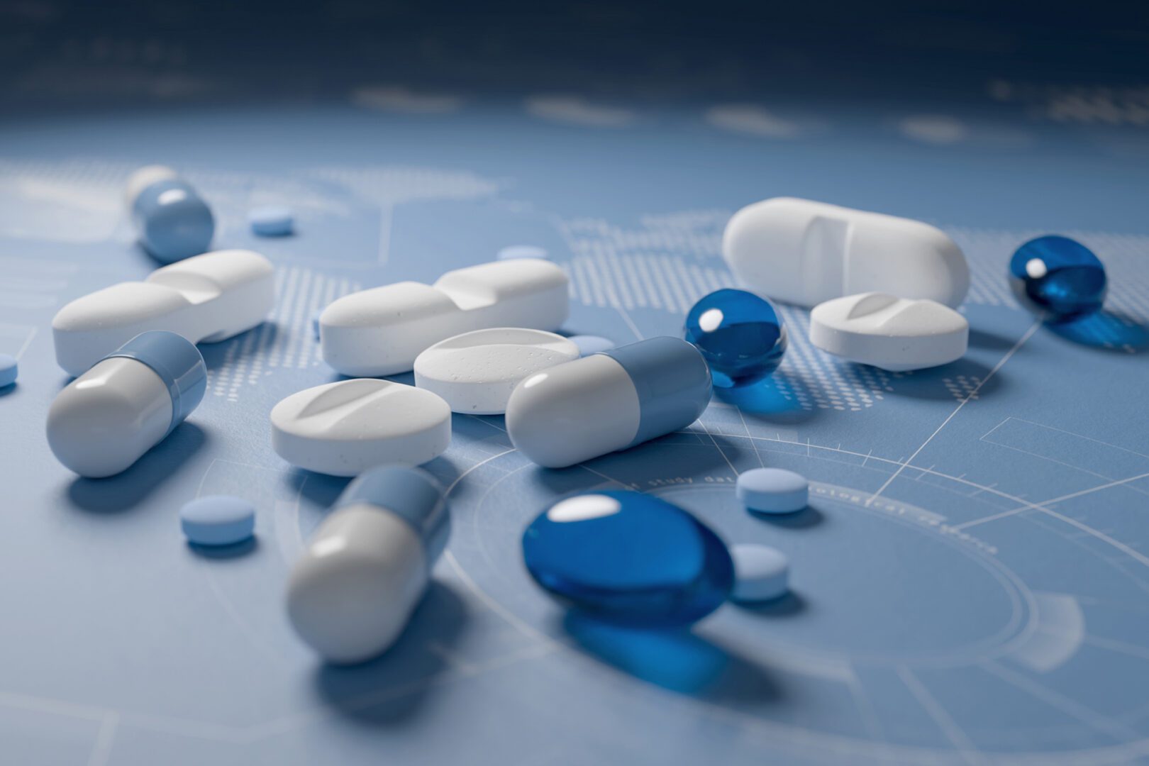 Various pills scattered on blue surface