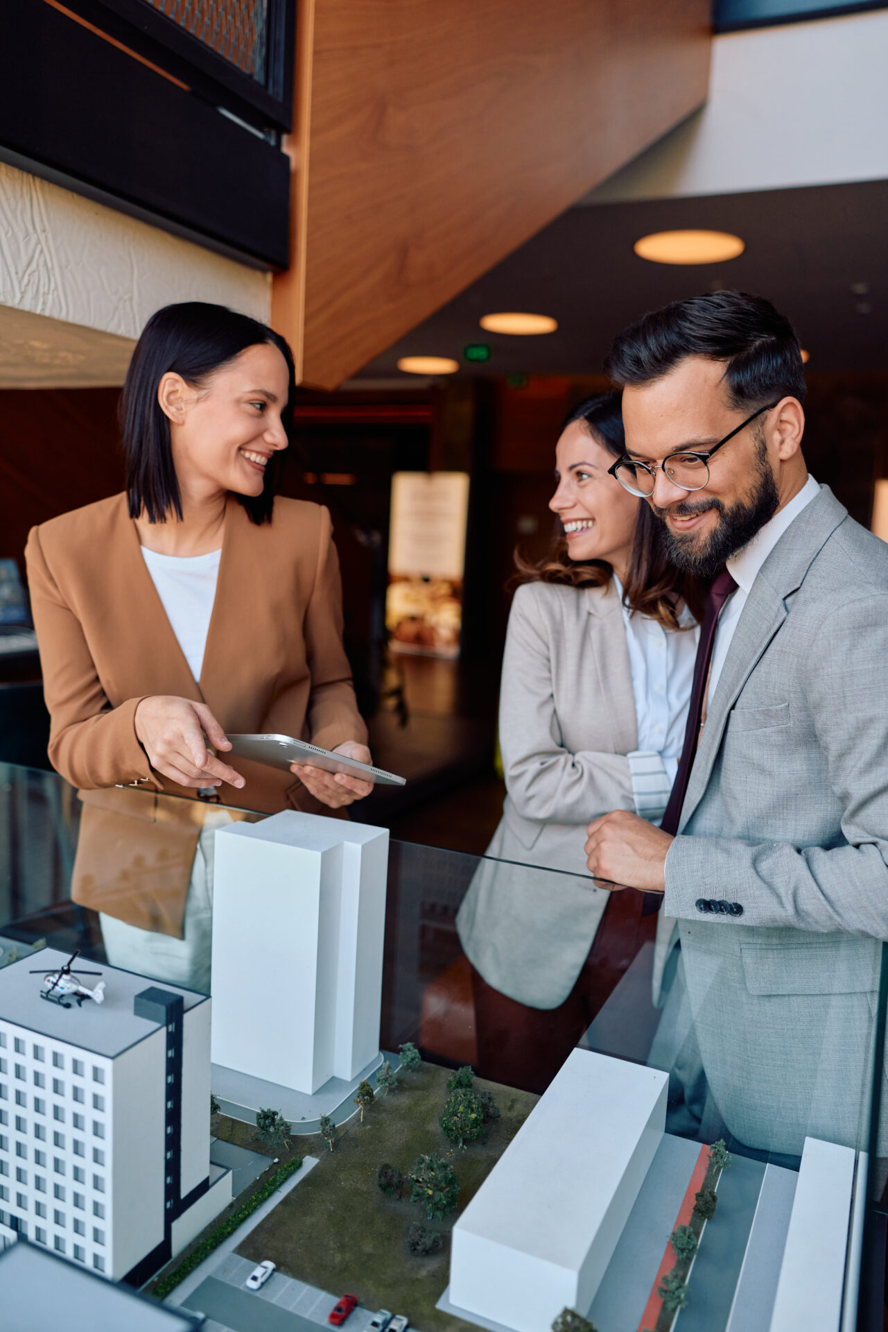 Group examining architectural model in office