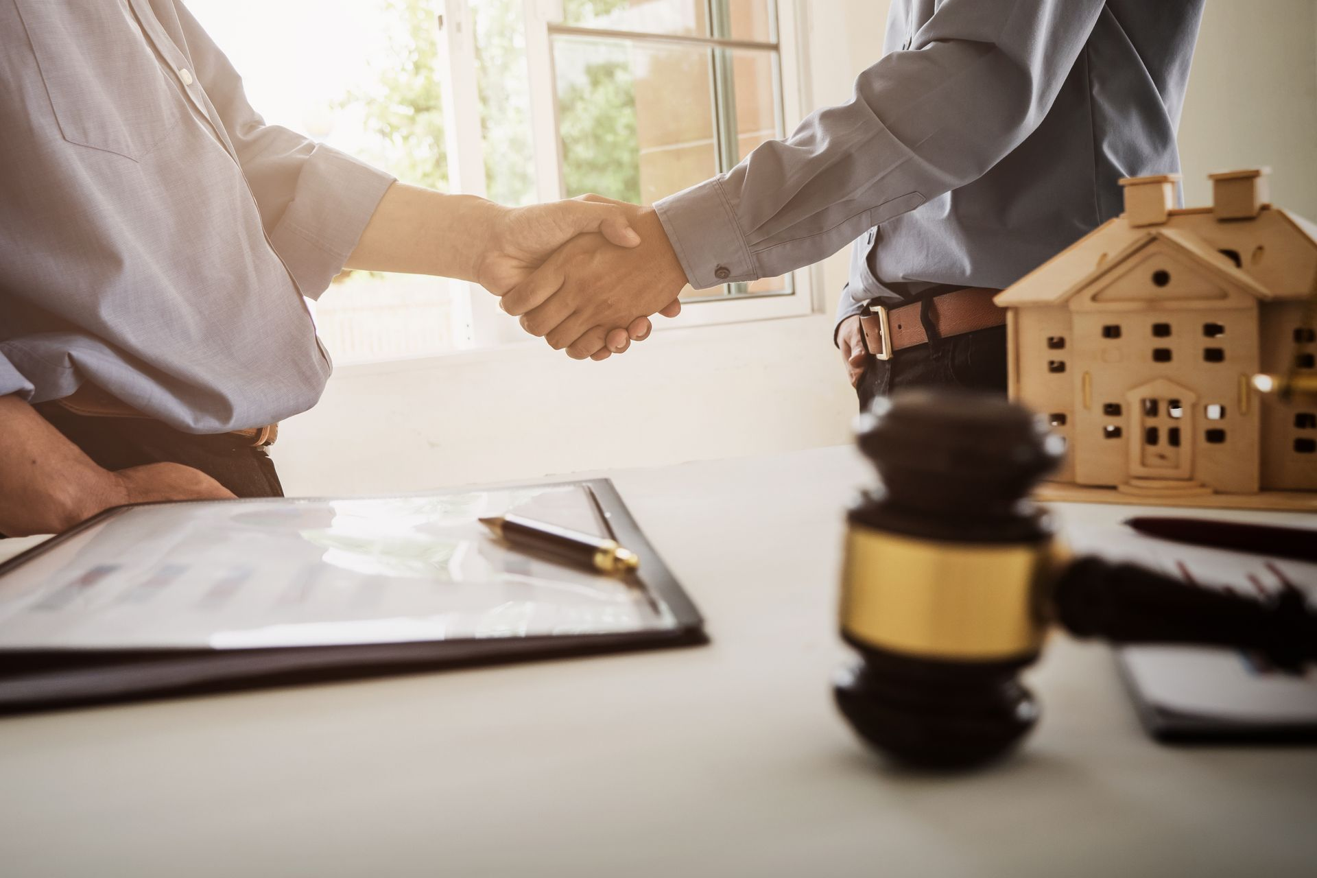 Two people shaking hands, legal setting