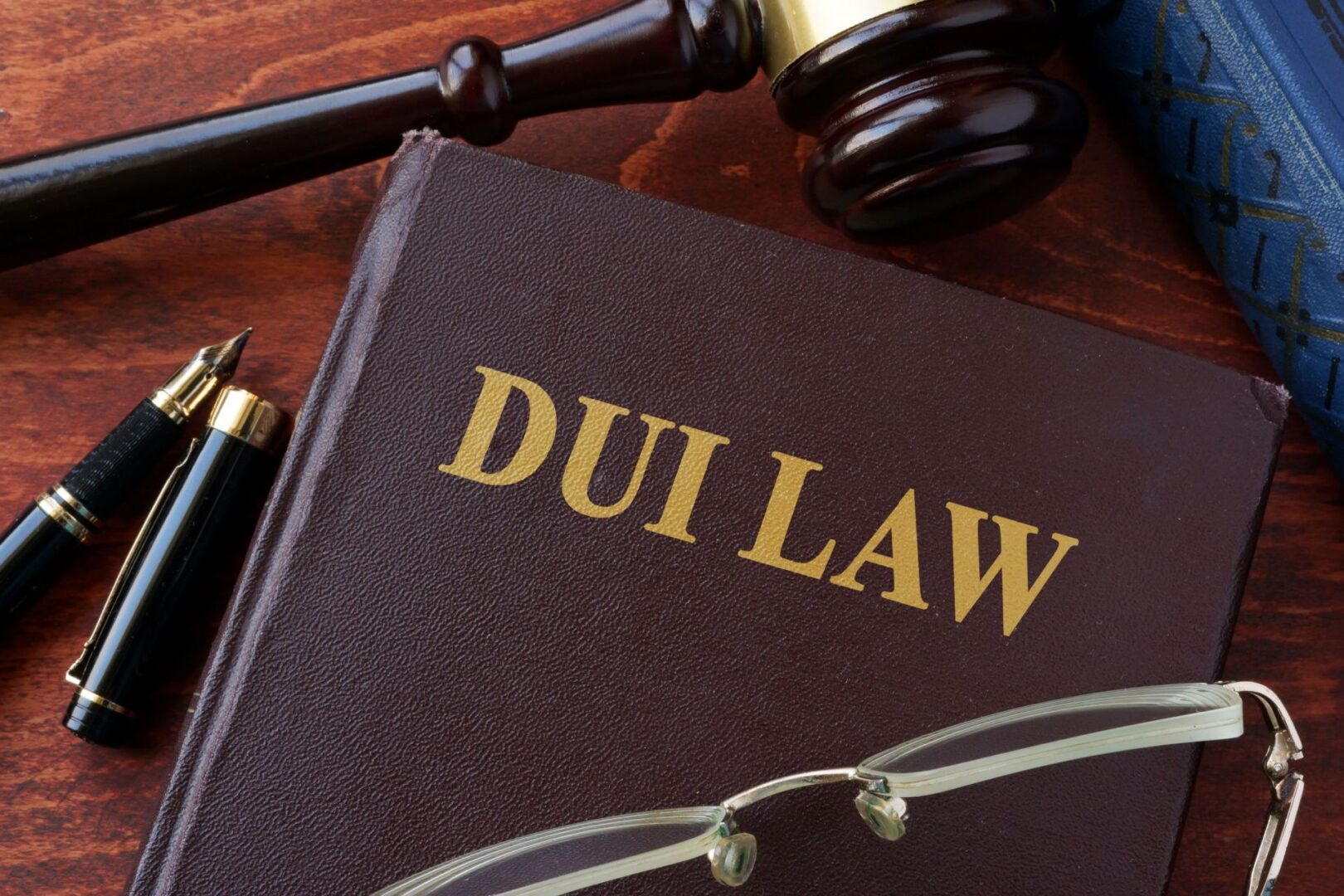DUI law book with gavel and glasses