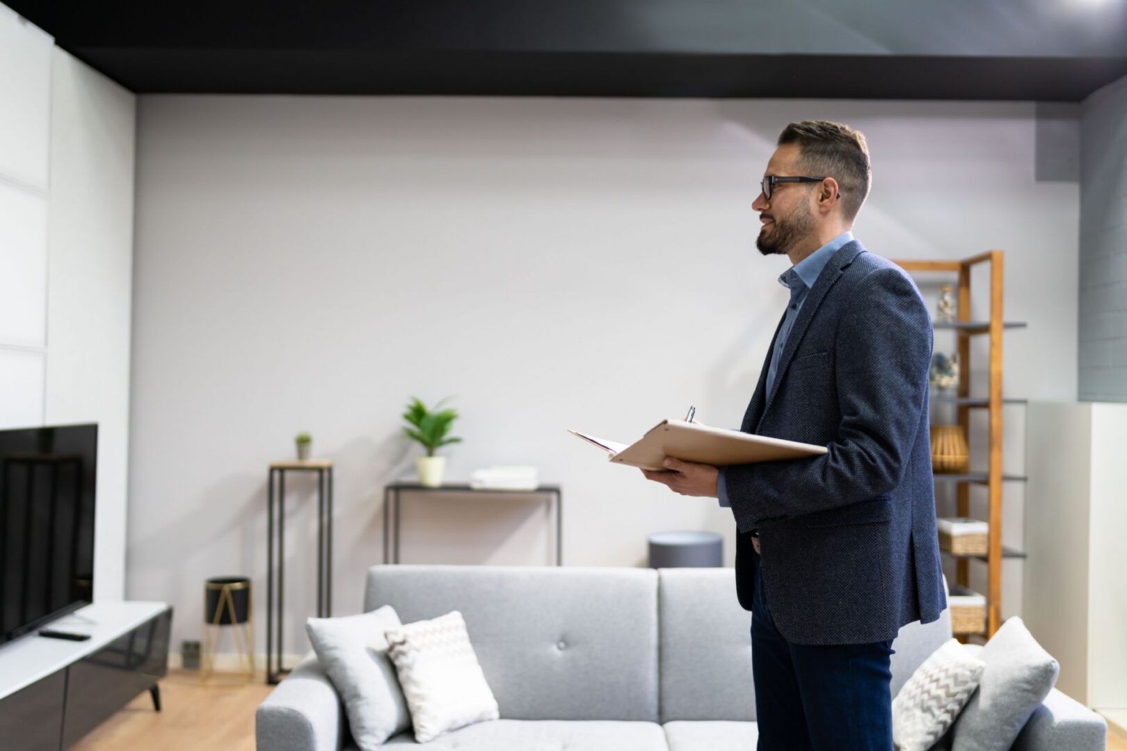 Man holding clipboard in modern living room